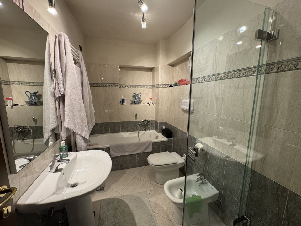 One bathroom is additionally equipped with a bathtub