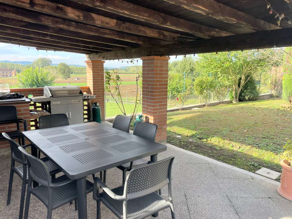 The summer seating area in the garden under the portico